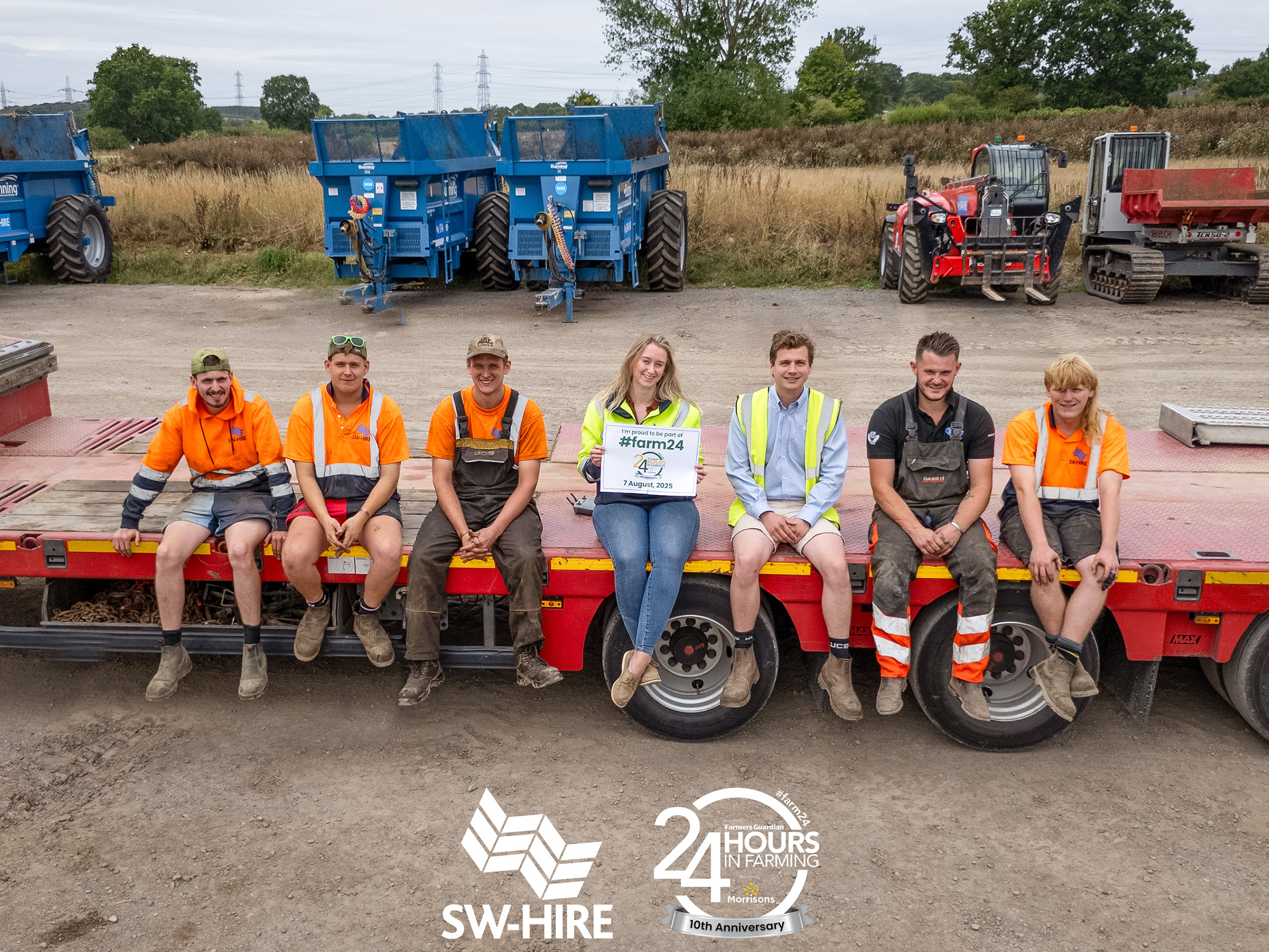 SW Hire team sat on red lorry lowloader in front of Bunning muckspreaders and manitou telehandler